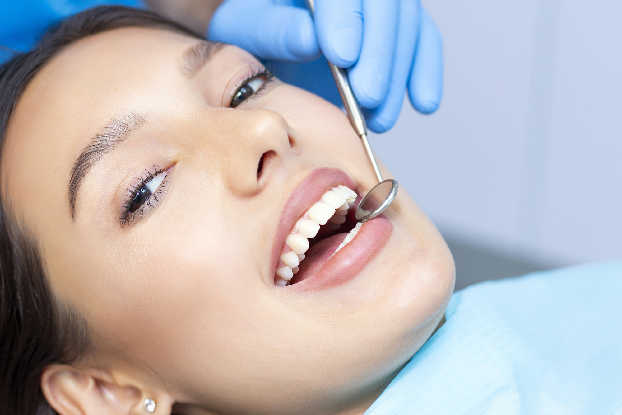 woman laying in dental chair preparing for dental crowns