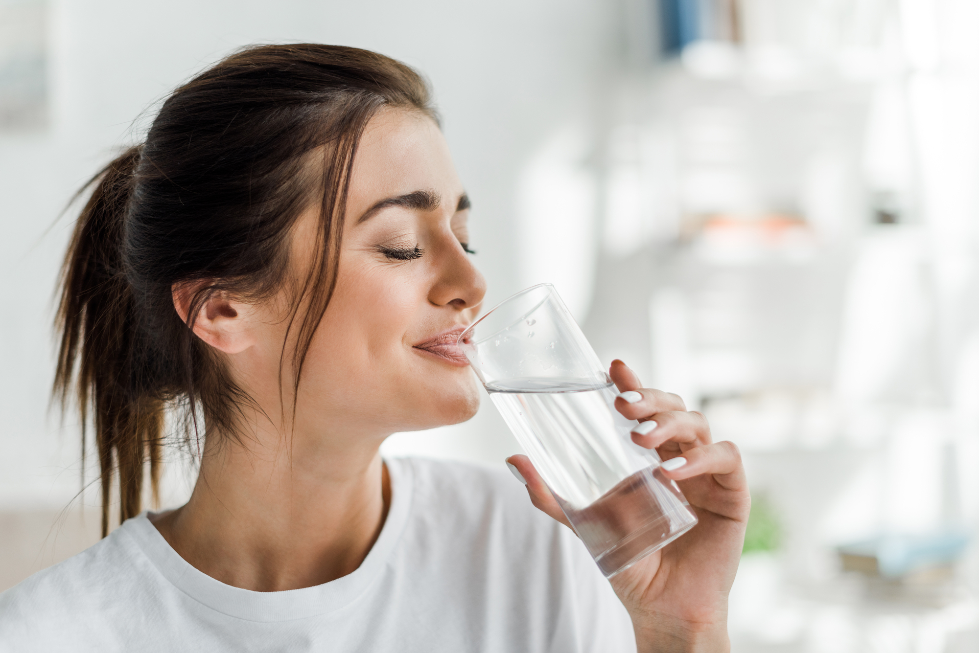 woman drinking water after root canals